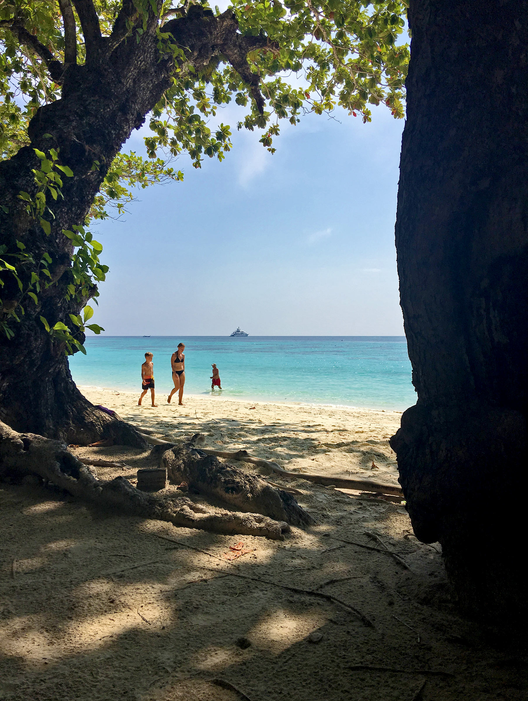 Superyacht seen from an island beach in southern Thailand